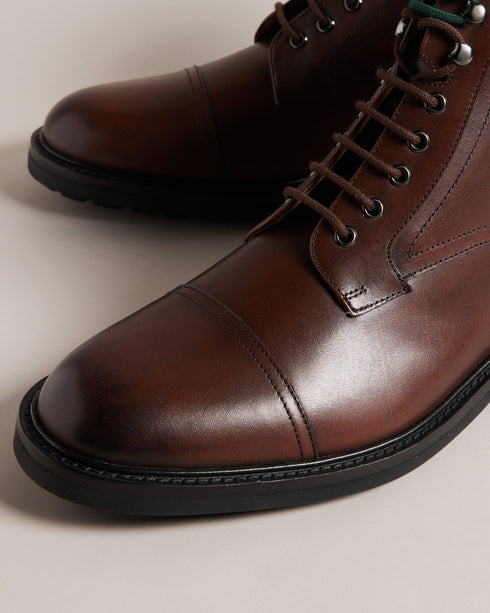 JOESIF-Boots-Step up your footwear game with our JOESIF leather boots. Crafted from top grain leather, these boots boast a lace fastening with eye-catching two-tone laces that add a touch of unique charm, while the heel pull tab ensures easy on-and-off. Leather boots Lace fastening Two-tone laces Ombre toe Webbing heel pull tab Vulcanised rubber sole- Ted Baker Romania